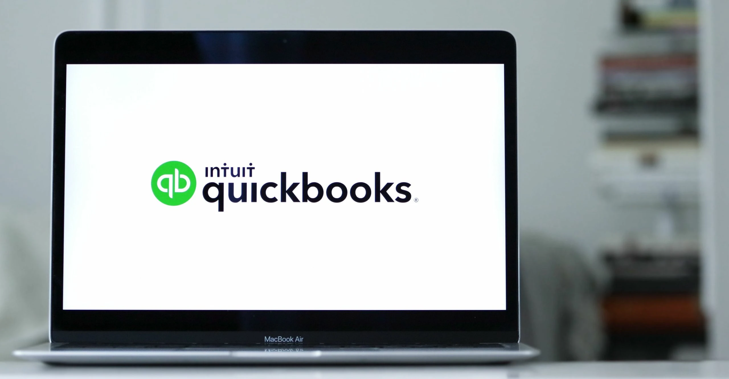 Laptop displays the logo of Quickbooks an accounting software program Laptop displays the logo of Quickbooks an accounting software program